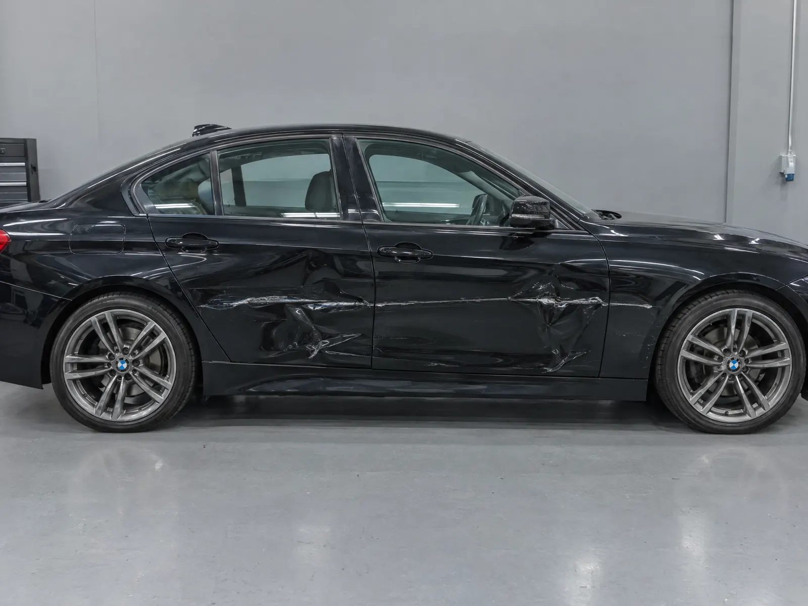 Before repair: Luxury sedan · key scratch and door dents